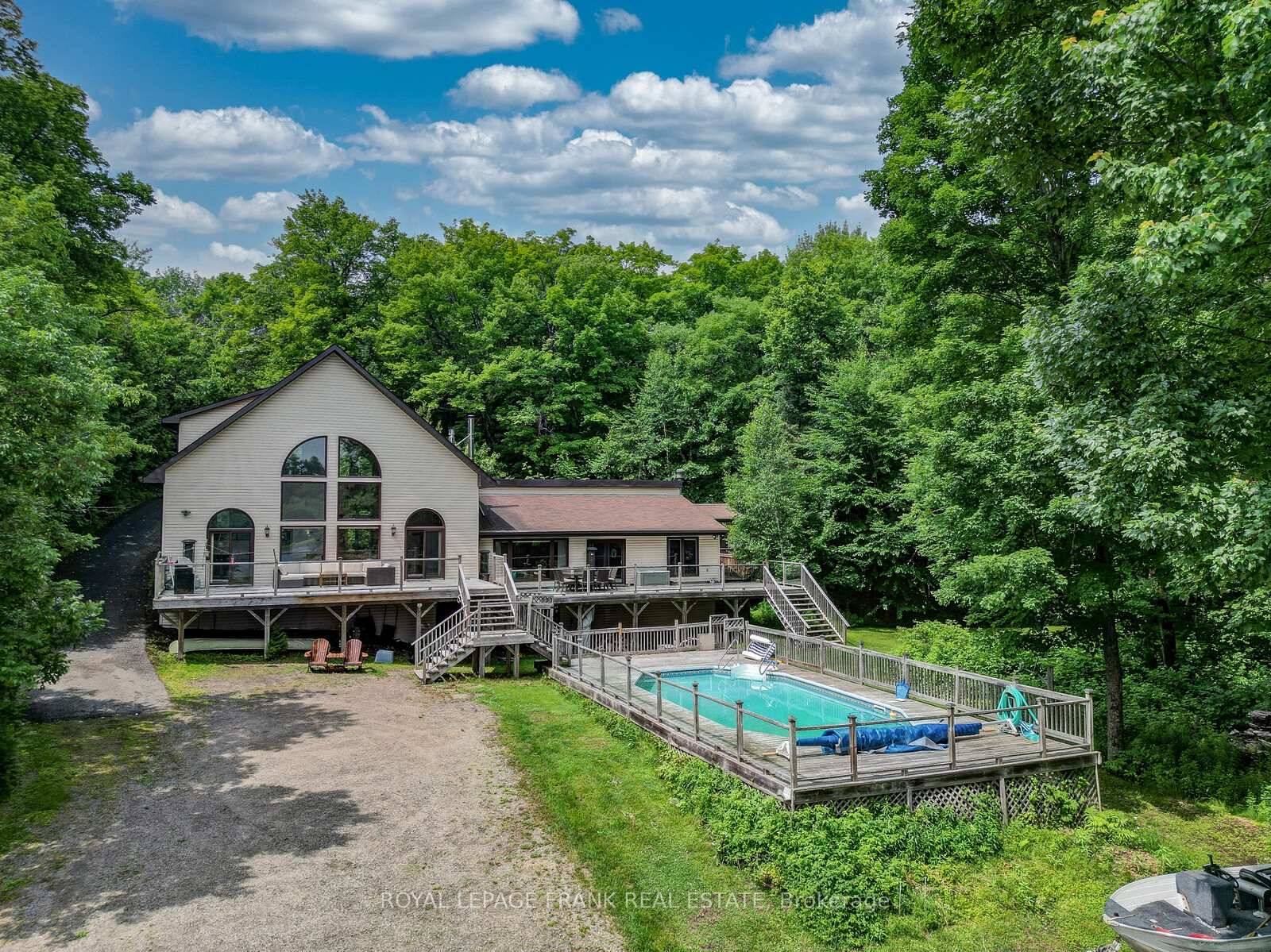 MUSKOKA Waterfront Oasis, just under 4 acres on desirable Wood Lake.