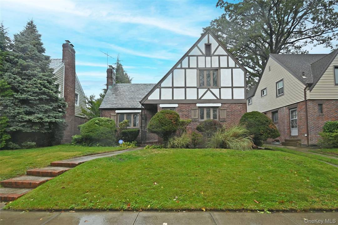 Step into this tastefully gut renovated English Tudor style home, featuring four spacious bedrooms and three beautifully designed bathrooms.
