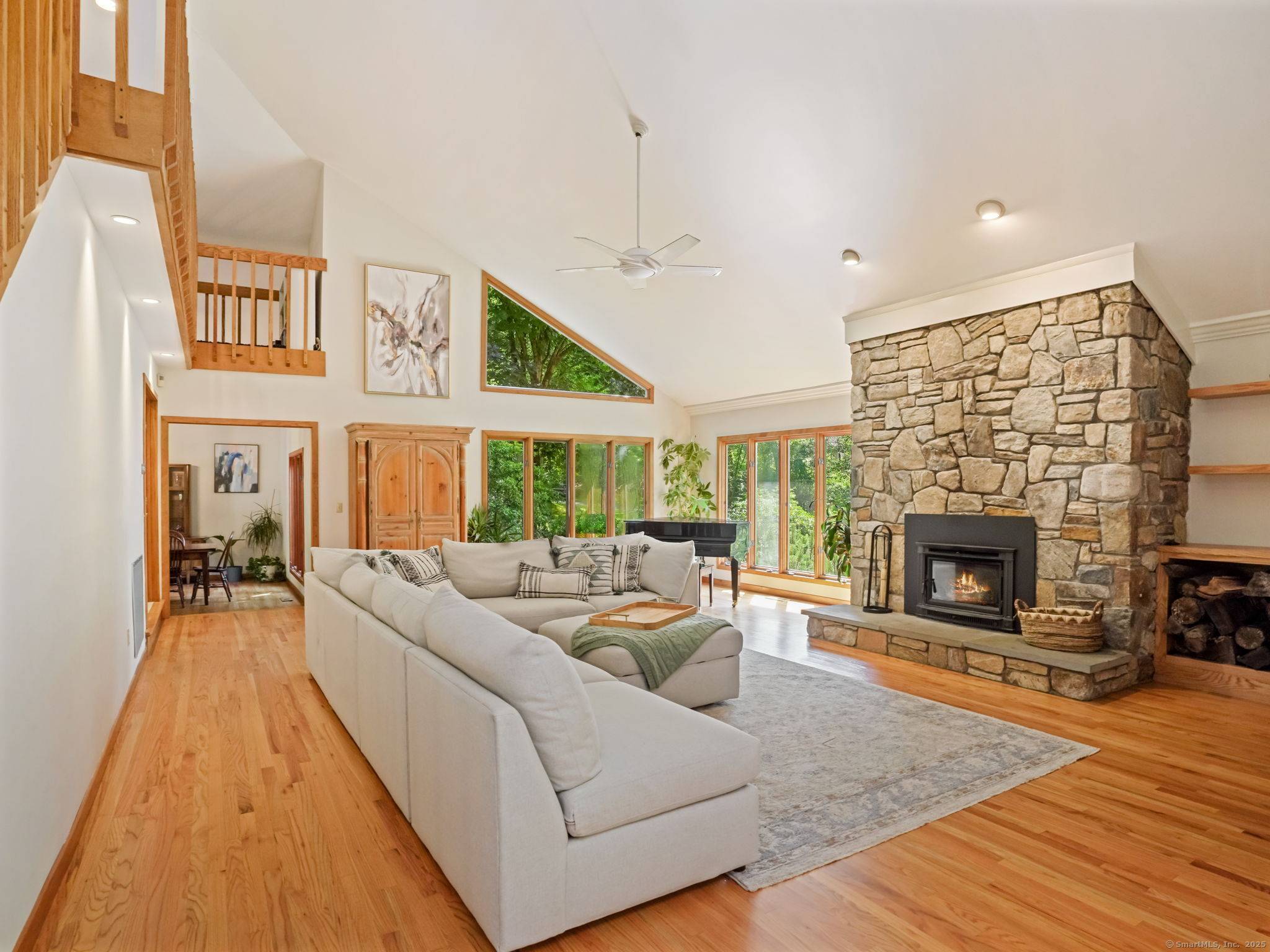 Natural light, soaring ceilings, and a dramatic stone fireplace set the tone for this spacious contemporary on one of the best lots in a quiet cul de sac.