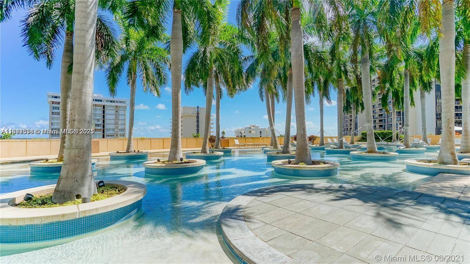 Experience elevated luxury on the 48th floor of the prestigious Four Seasons Residences in Brickell.