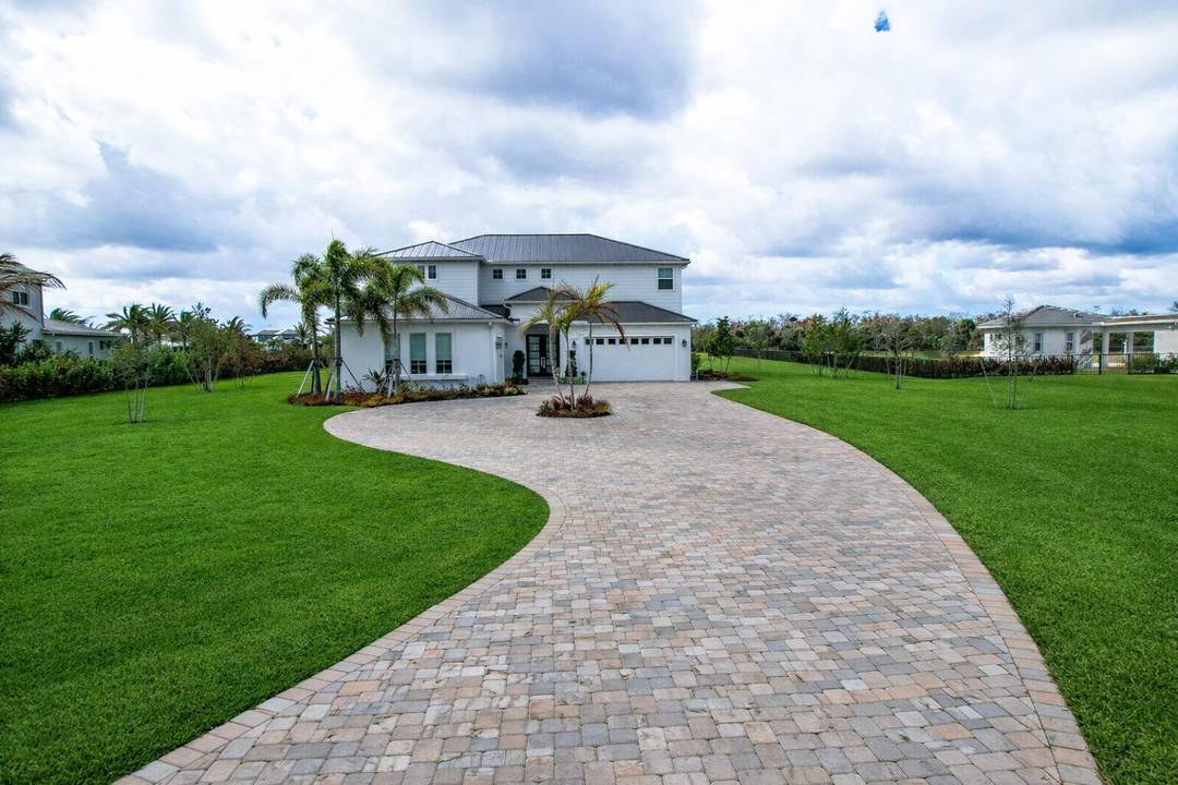 Experience unmatched luxury in this completely reimagined home in the prestigious Bridgewater community of Jupiter, set on an expansive cul de sac, 2 acre lot.