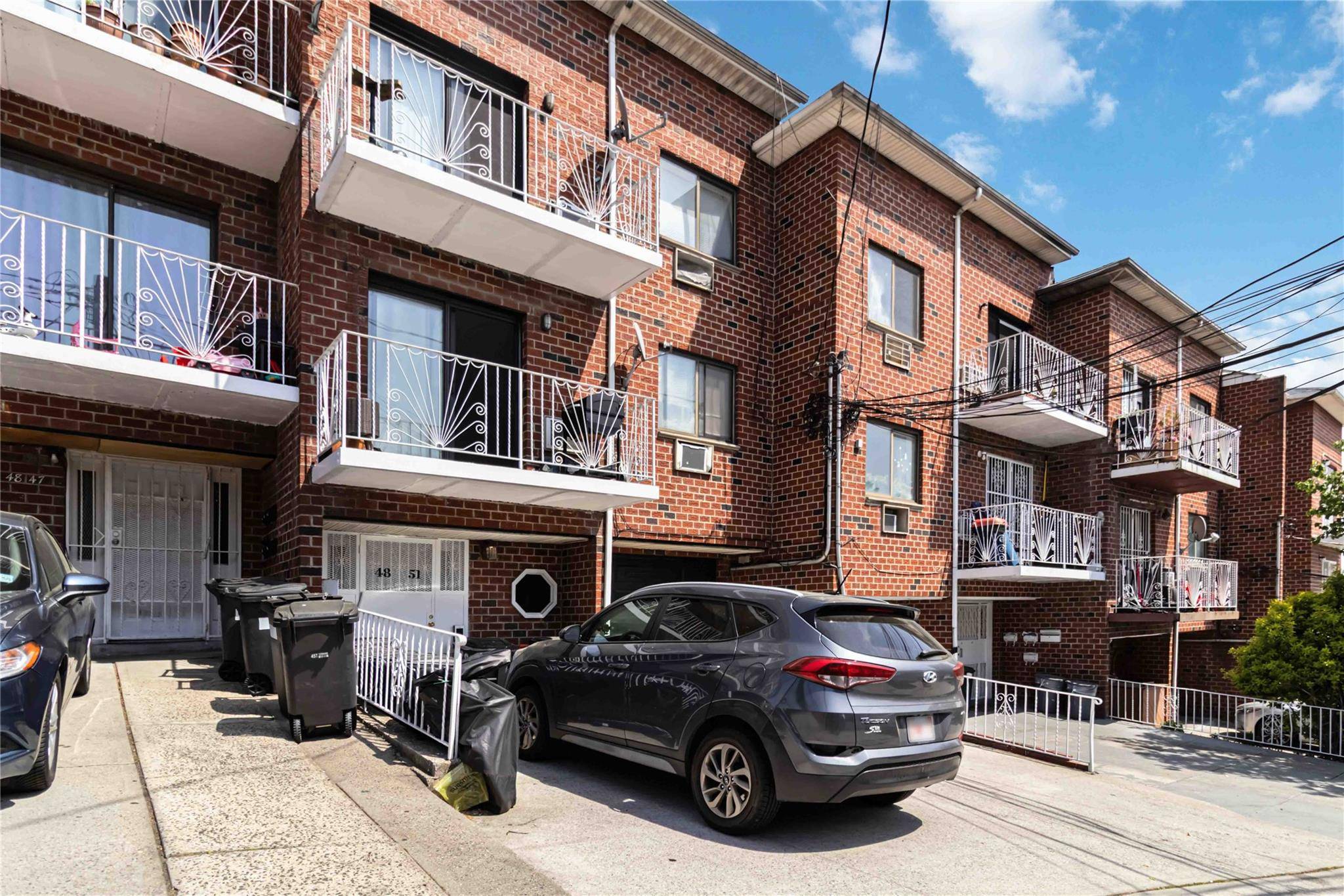 Solid brick 4 family built in 1985 featuring spacious units with hardwood floors, granite countertops, updated cabinets, and private balconies in every apartment.