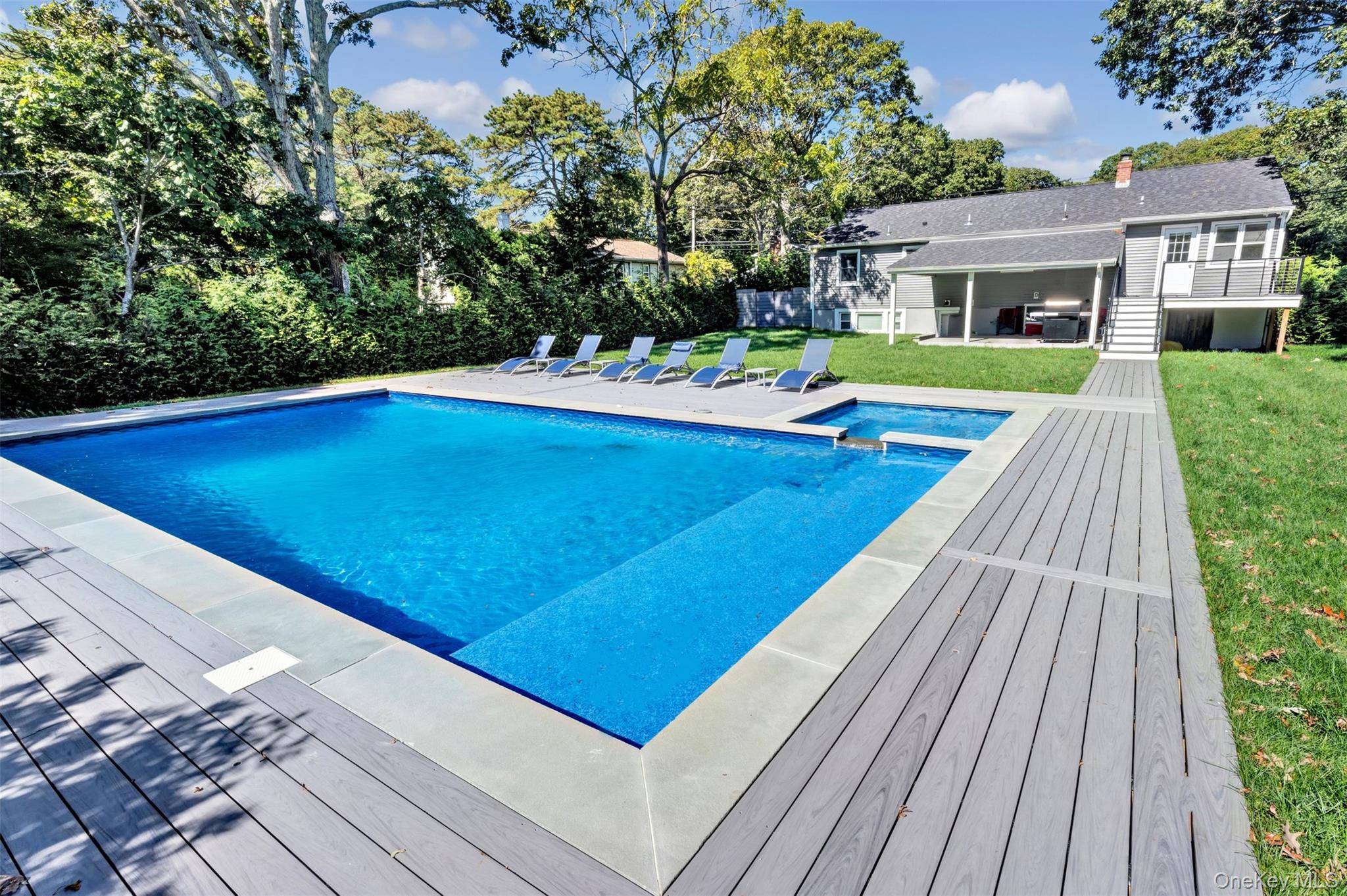 Resort style living in the very heart of vibrant and desirable Hampton Bays !