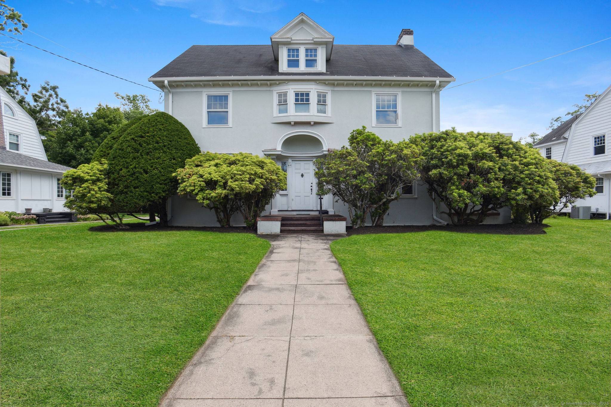 A stately, gracious light filled stucco home is located on a very desirable quiet tree lined Westville street.