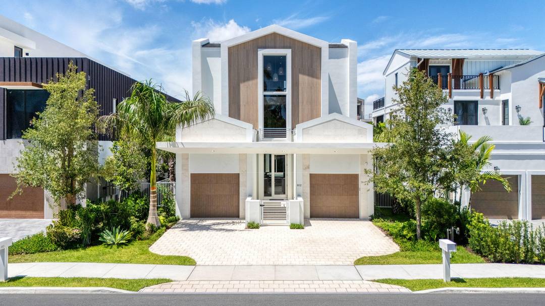 Coastal charm meets modern living on highly desirable Palm Trail in this new construction gem.