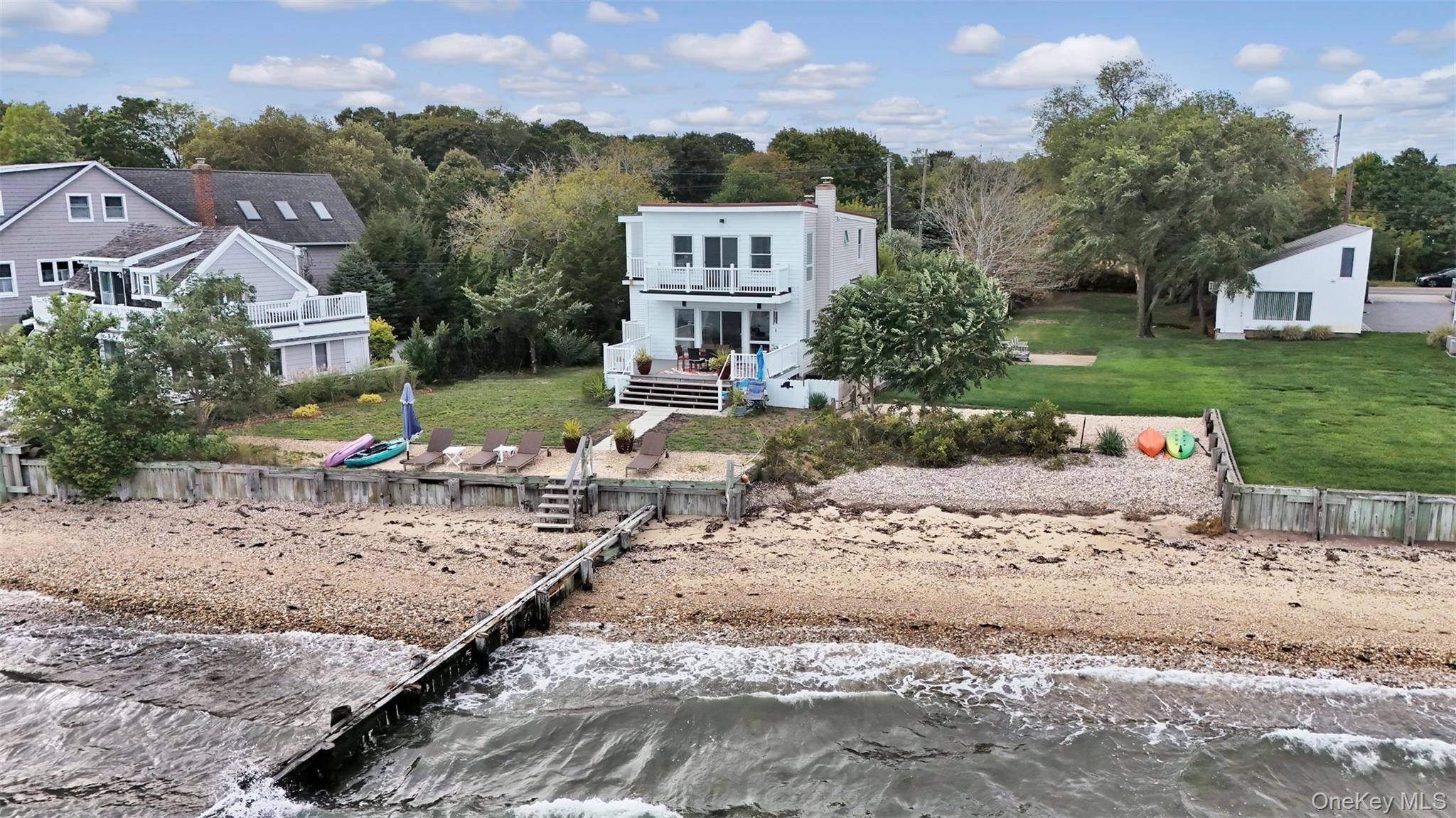 Welcome Home to 12960 Main Road, a Rare Bayfront, Beachfront Beauty !