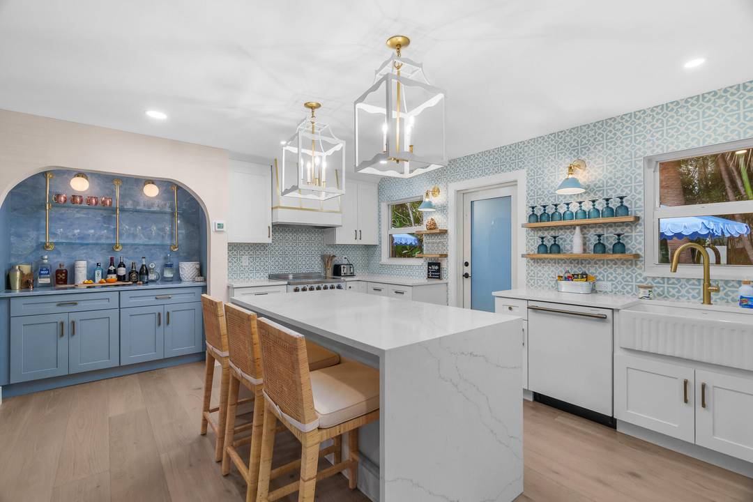 Escape to coastal bliss in this immaculety remodeled, turnkey furnished beach cottage, just steps from the sand and surf in Ocean Ridge.