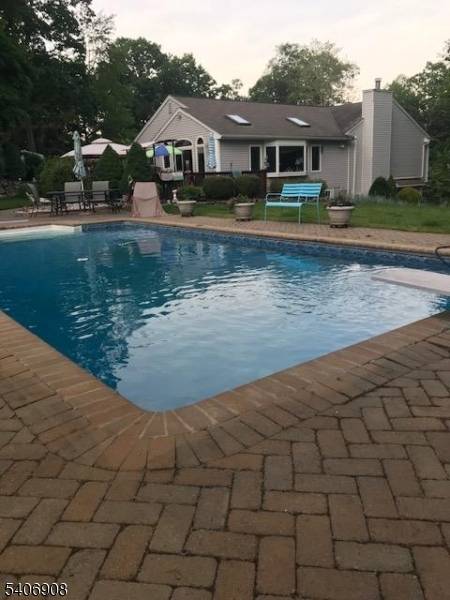 Welcome to 24 The Loop, a custom home in Cupsaw Lake that has been enhanced by a significant addition that introduced an impressive great room and an expansive primary suite.