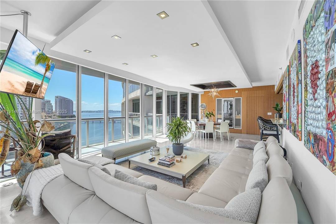 Stunning FURNISHED remodeled corner residence encased in floor to ceiling glass frames the picturesque views.