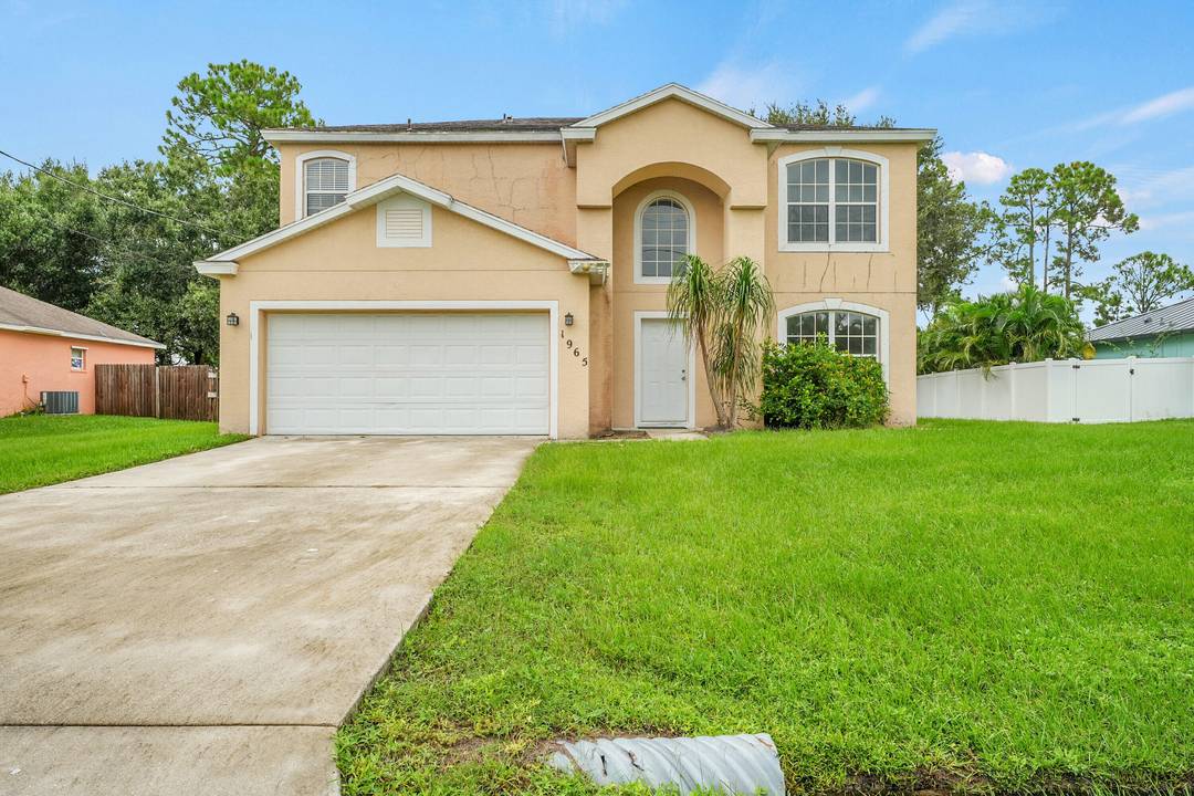 Spacious two story home featuring a formal dining room, sitting room foyer combo, galley kitchen, family room, and half bath on the main floor.