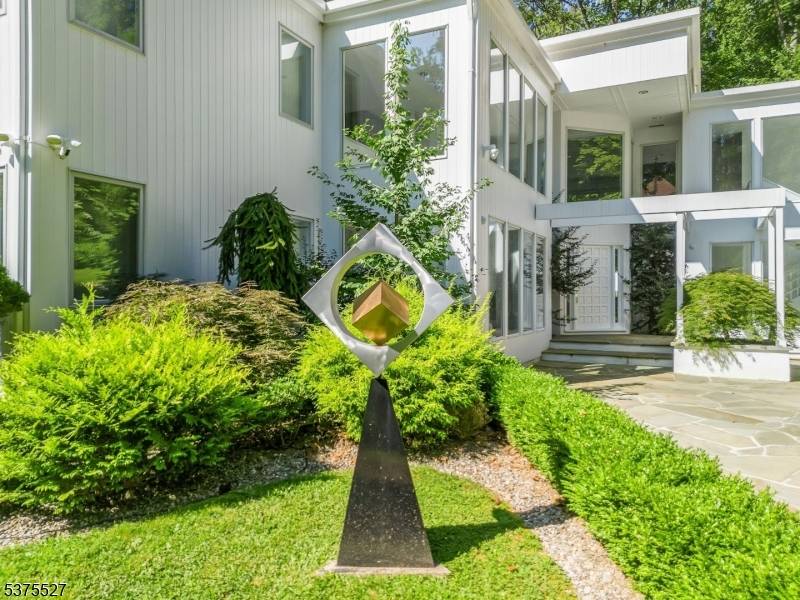 LIVE LIKE YOU JUST STEPPED OUT OF THE PAGES OF ARCHITECTURAL DIGEST IN THIS EXTRAORDINARY MODERN ESTATE NESTLED ON OVER 5 PRIVATE ACRES IN BERNARDSVILLE, NEW JERSEY.
