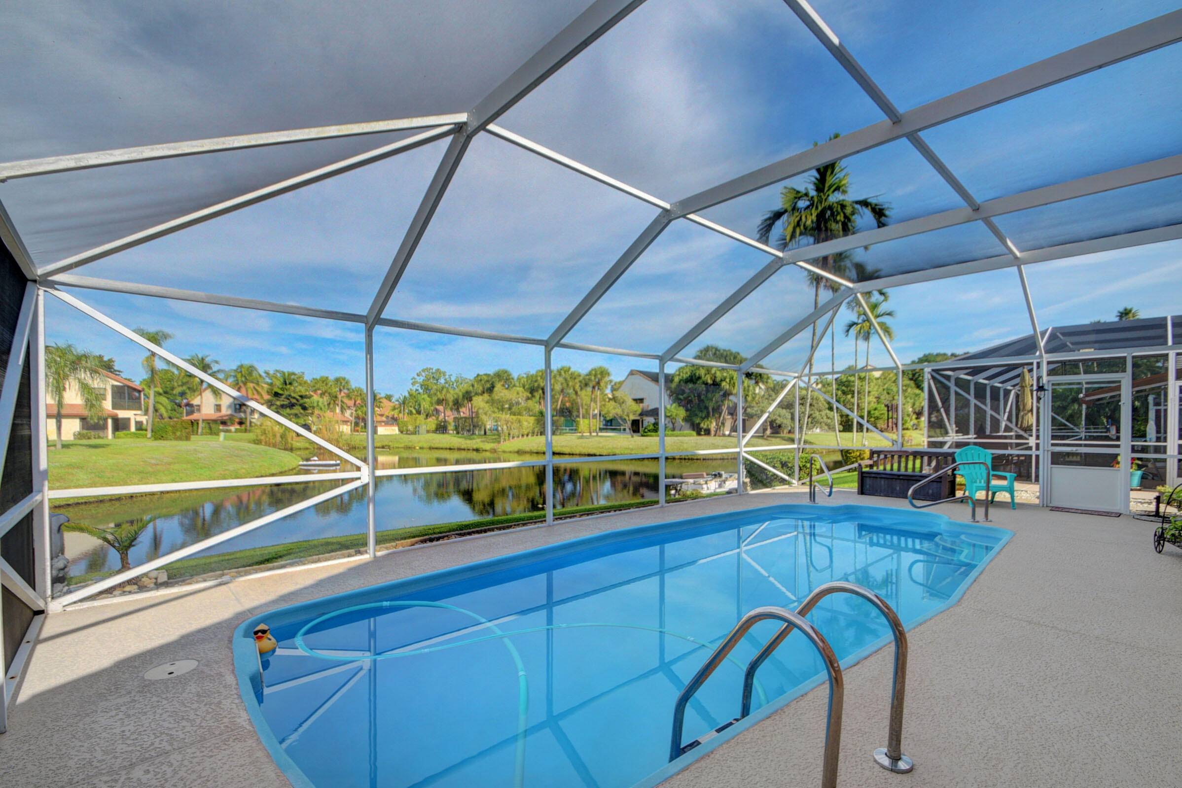 Step into a world of refined comfort with this exceptional 3 bed, 2 bath Wellington home by a tranquil lake.