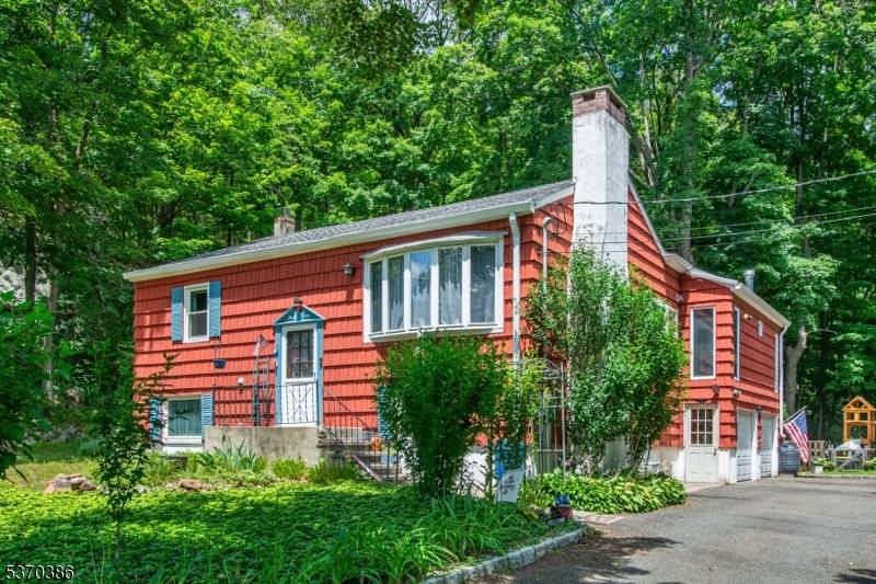Welcome to 34 Ricker Road, a charming custom home set on a private 2 acre lot in the heart of Kinnelon.