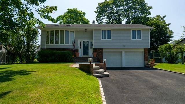 Welcome to this spacious and beautifully maintained 3 bedroom, 2 bathroom high ranch, perfectly situated in the heart of East Islip.