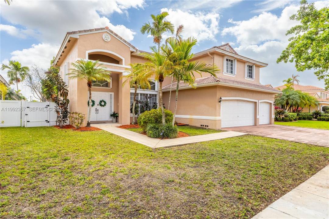 Beautifully maintained Pembroke Pines home featuring a soaring loft style living room that creates a grand, open and airy feel.