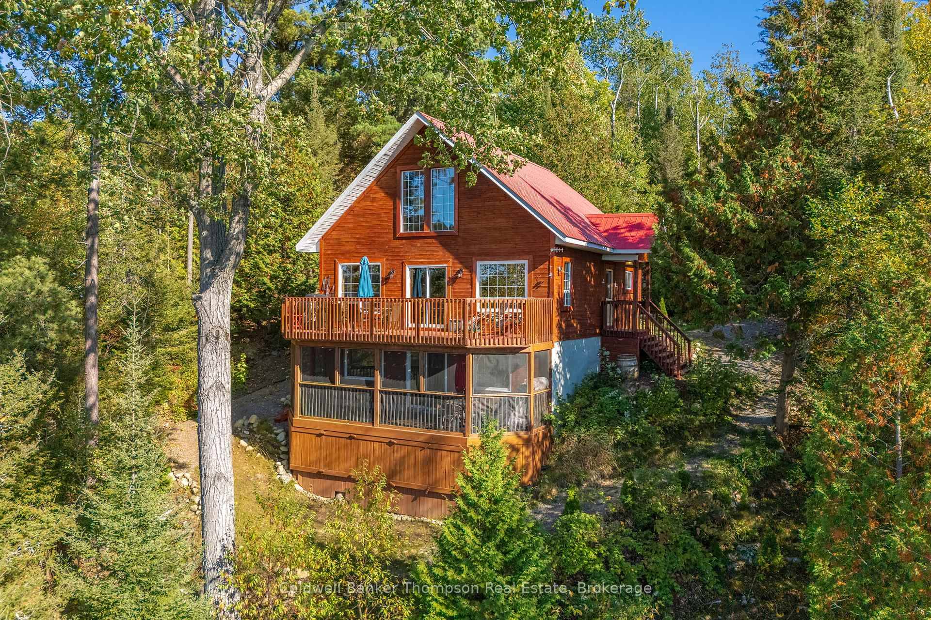 Welcome to this warm and inviting 3 season chalet style cottage, red pine finished amp ; tucked among the trees with an elevated view of Forest Lake.