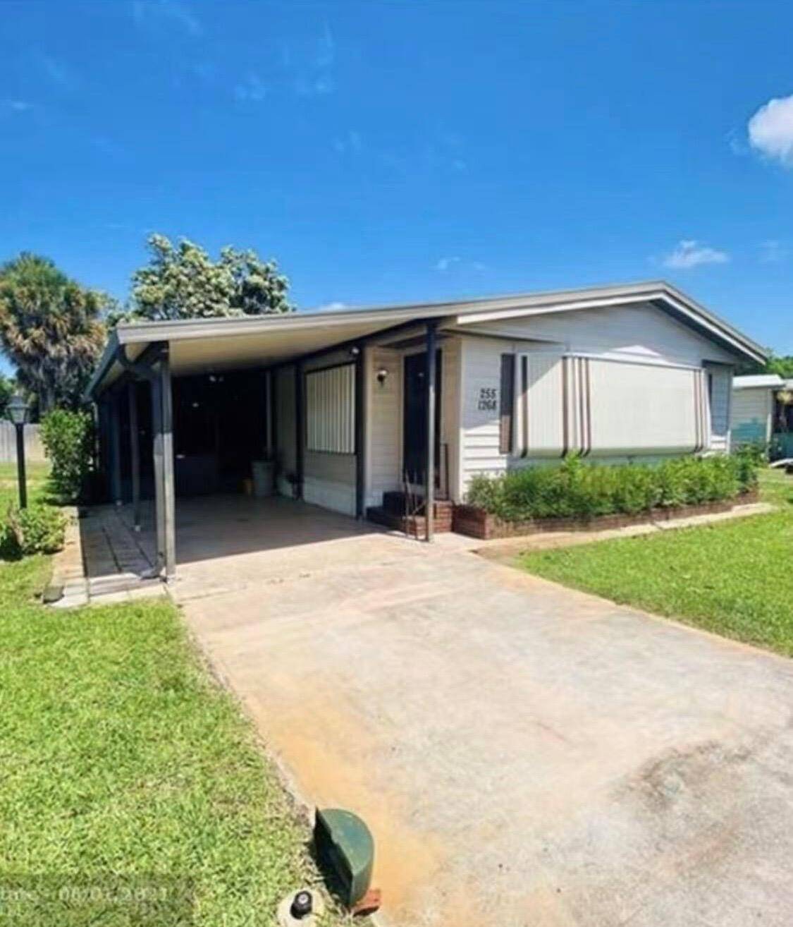 SPACIOUS AND BEAUTIFUL DOUBLE WIDE MOBILE HOME ON THE LARGEST LOT IN PALM BEACH COLONY.