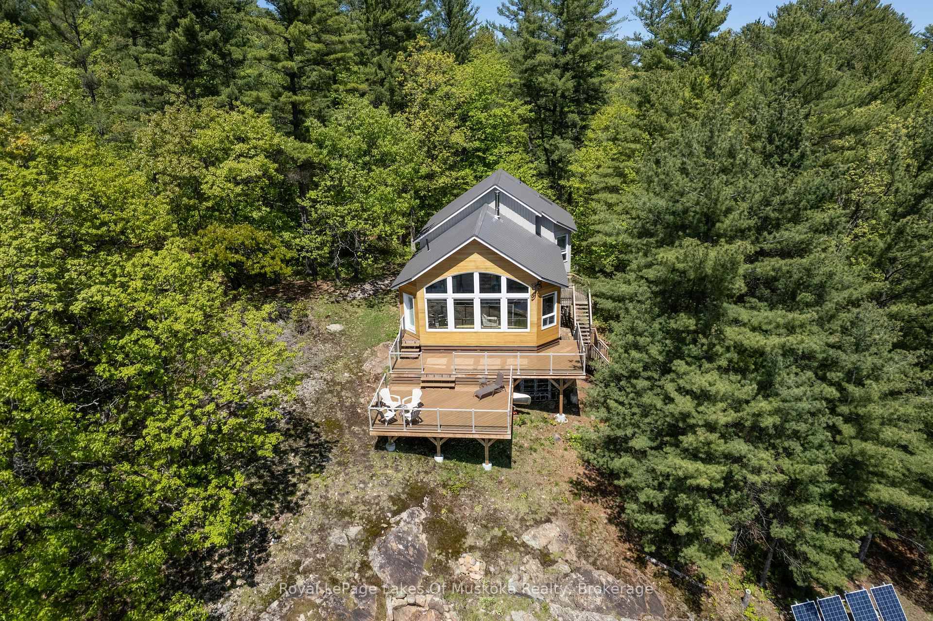 A wall of windows greets you as you arrive at this wonderful south facing granite perched charmer.
