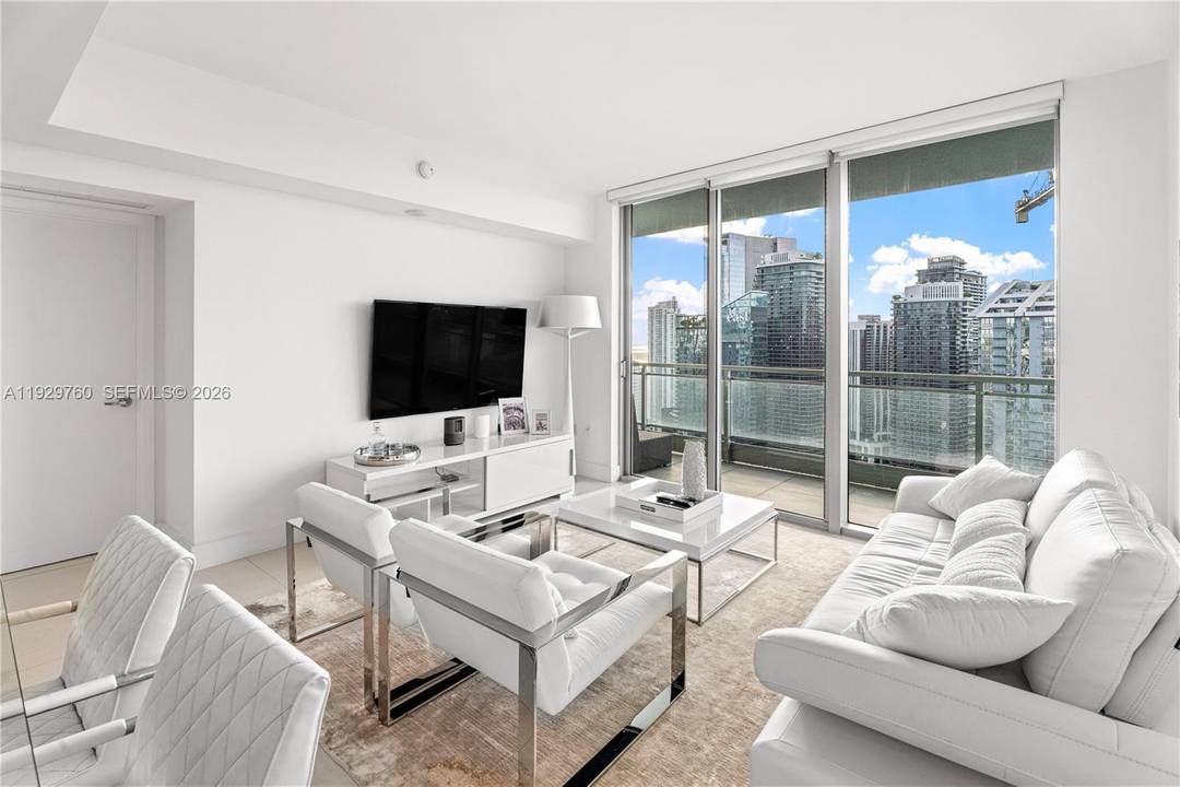 Soaring from the 47 floor, this unit at The Mint offers sweeping, unobstructed views of the Miami River, Brickell skyline, amp ; the glittering city below.