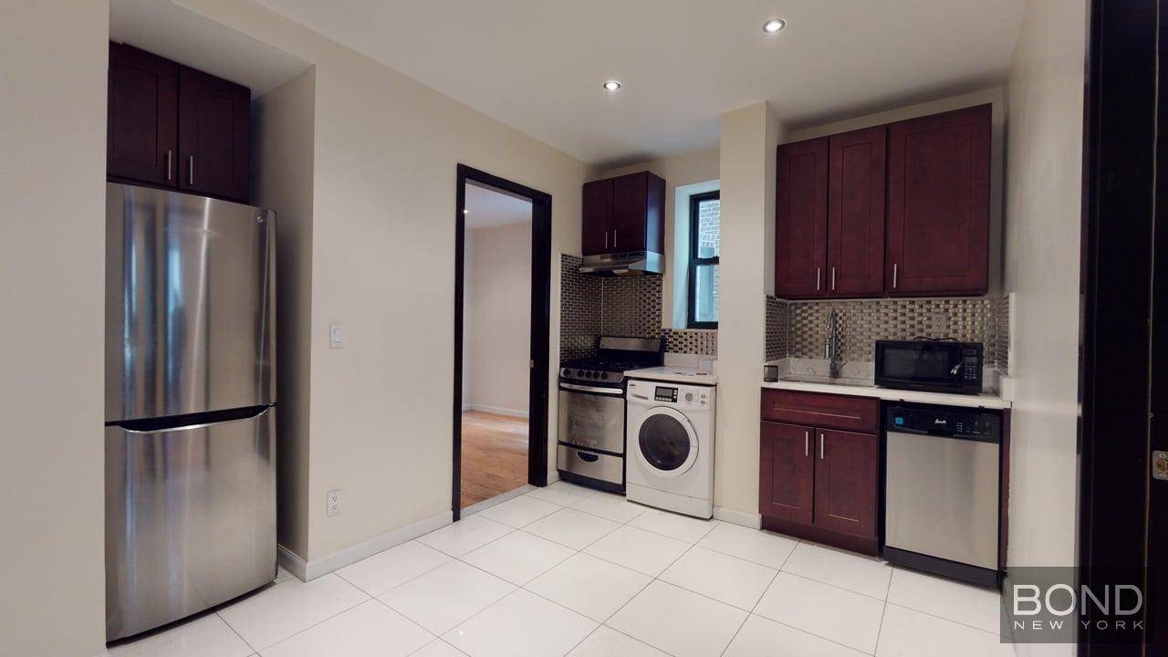 Large open Eat In kitchen with white marble counter top and Stainless Steel appliances.