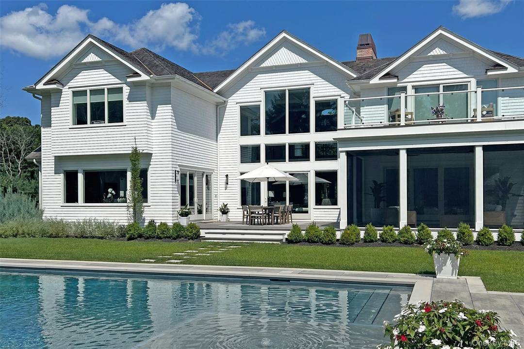 Behind a gated entry on 2 manicured acres, this exceptional estate is located on a serene cul de sac, south of the highway, in the Village of Quogue.