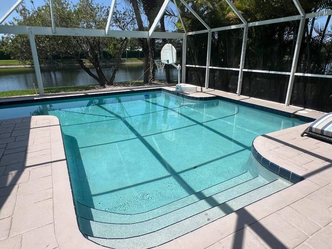 LOVELY THREE BEDROOM 2. 5 BATH TWO STORY HOUSE WITH POOL OVERLOOKING A PONDAT BREAKERS WEST GATED COMMUNITY.