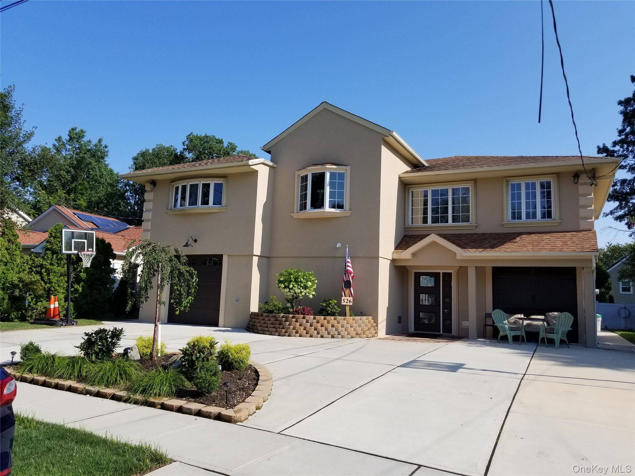 Elegant Living in Woodmere SD 14 A Refined Retreat on a Serene, Tree Lined Block Discover timeless comfort and modern elegance in this beautifully elevated home nestled in the heart ...