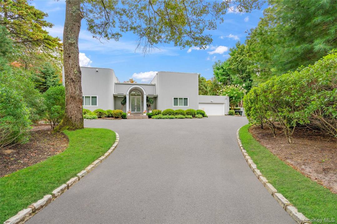 Tucked away on a peaceful lane is this beautifully updated contemporary that optimizes country living in the Hamptons.