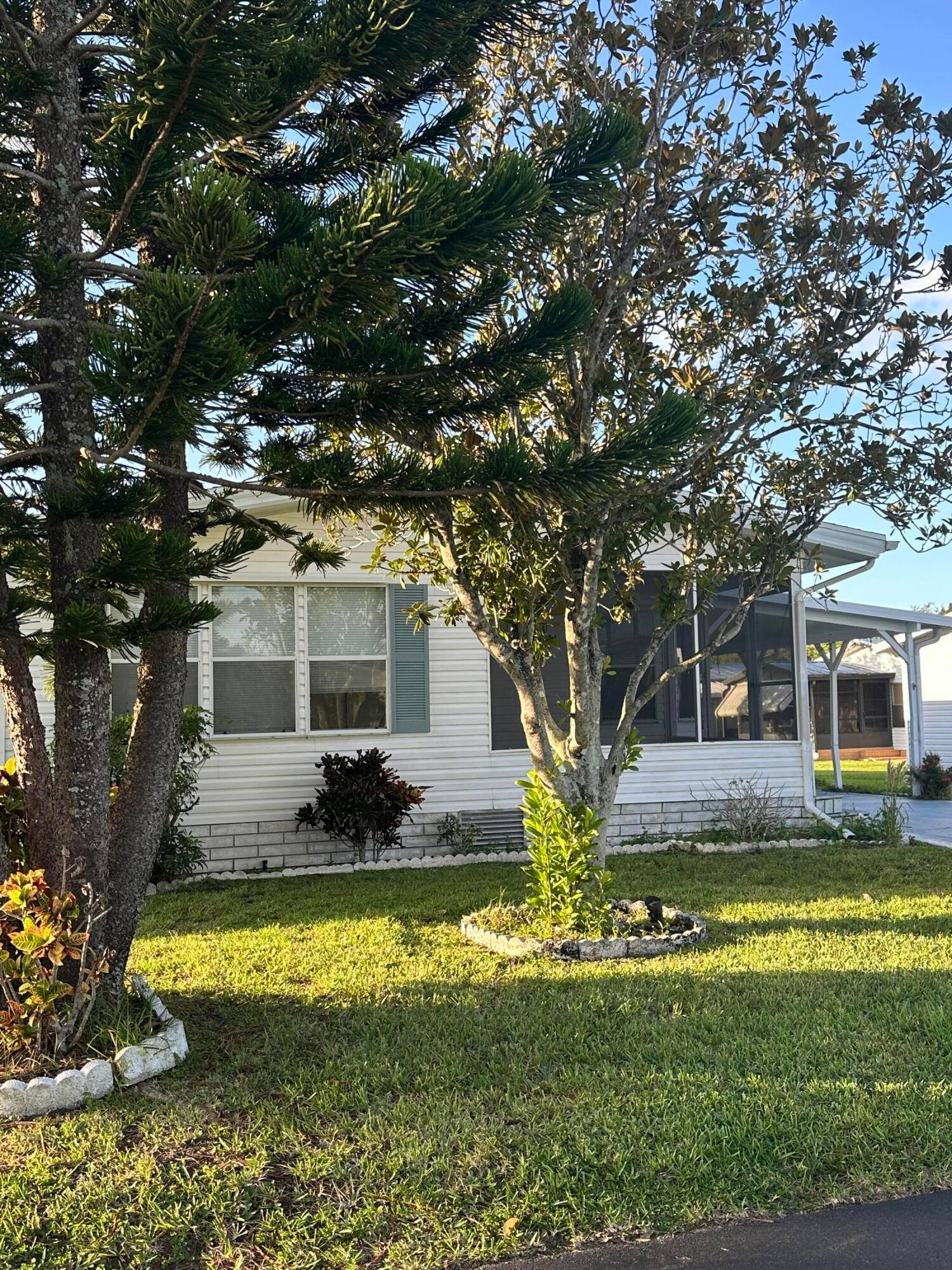 Beautiful home recently freshened up with flooring, paint, newer kitchen, large living area, eat in kitchen, Florida room, screened porch, dual sinks in master bath, large carport, shed and backs ...