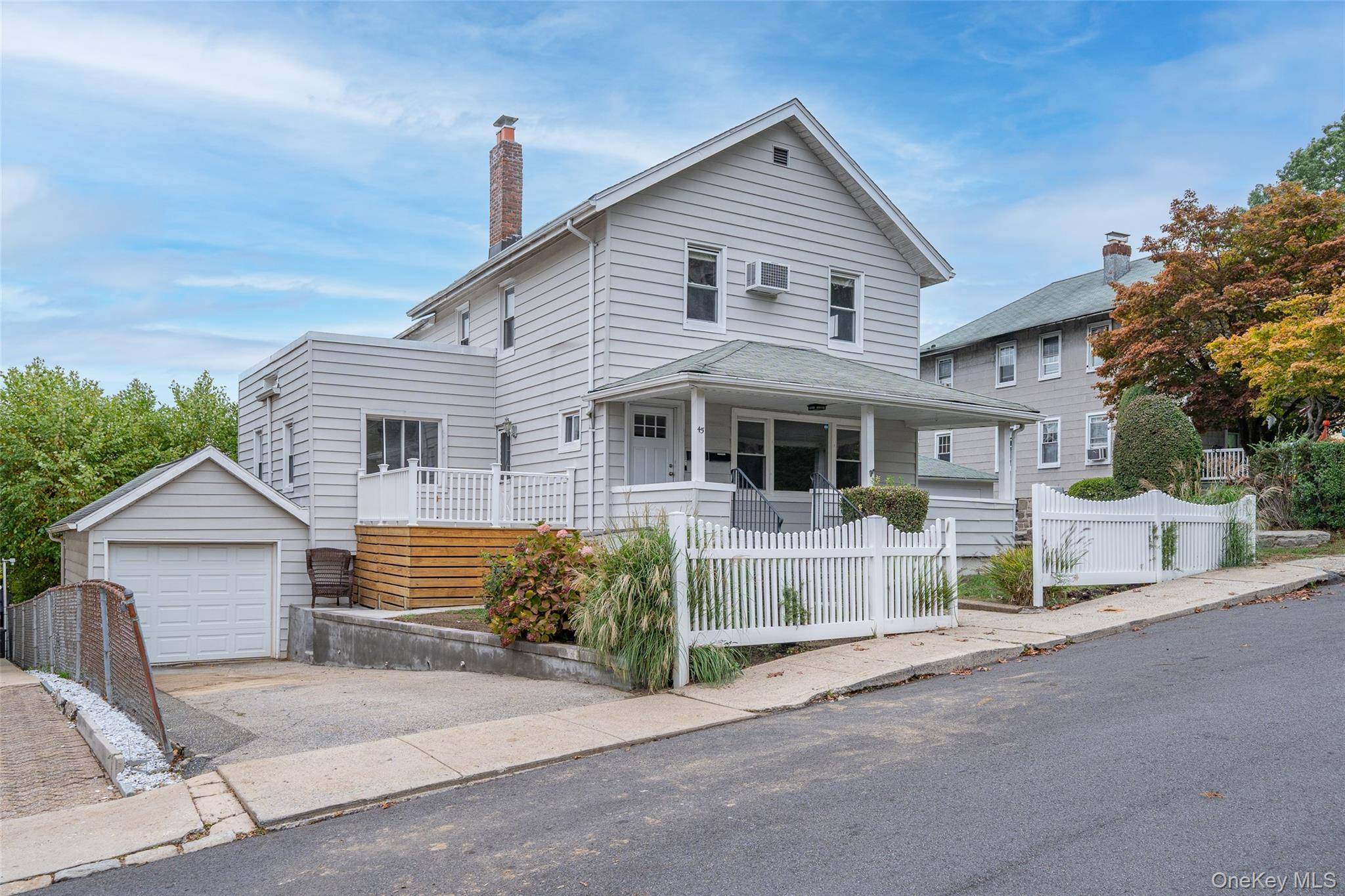 Commuters Dream ! Welcome home to this cozy 2 family home with a rocking chair front porch and a white picket fence !