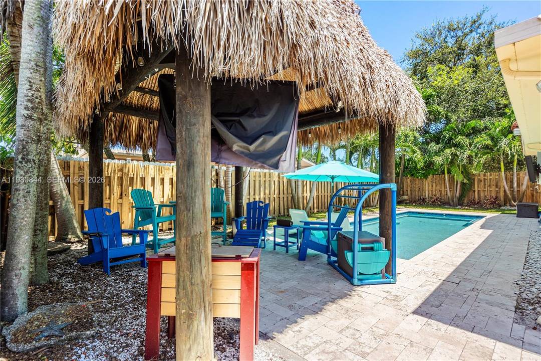 Beautiful and well maintained 4 bedroom 2 Bath pool home with sundeck and tiki hut in the desirable Palm Aire West neighborhood.