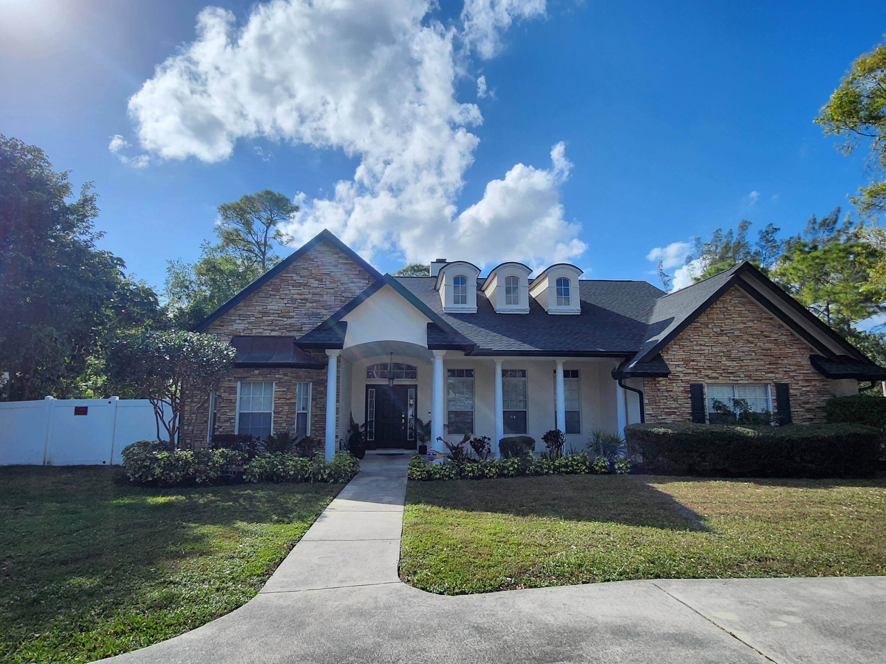 This exceptional home is located in the Equestrian Community known as the ''Acreage'' in West Palm Beach.