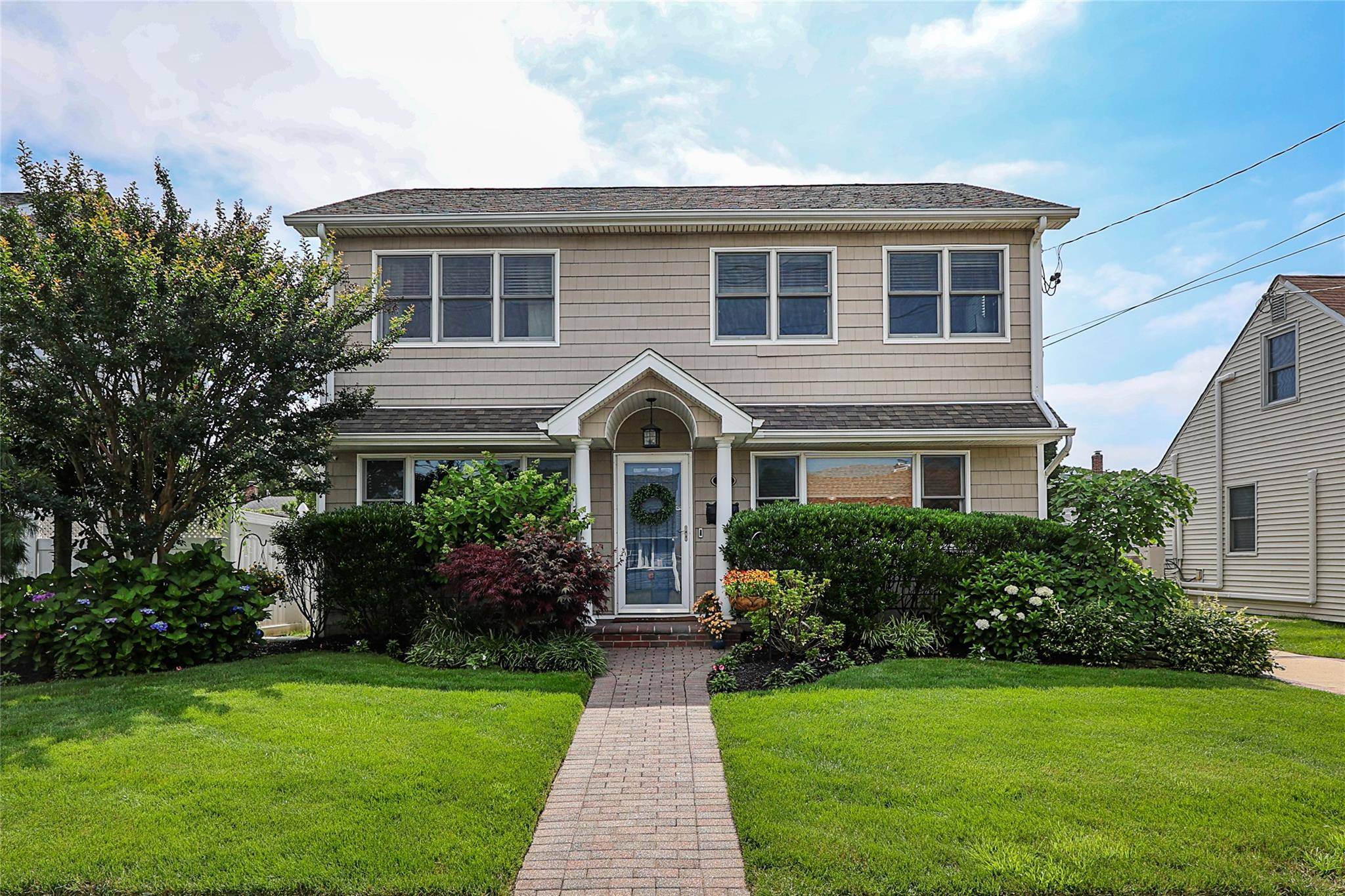 Nestled in the heart of Massapequa, this pristine colonial offers over 2, 100 sq ft of spacious living with an open and airy floor plan that buyers dream of.