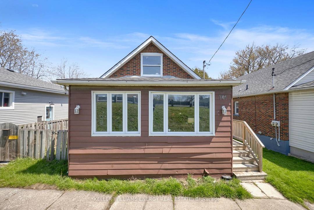Legal Duplex The main level features a bright living room, a functional den perfect for a home office, and a combined kitchen and dining area.