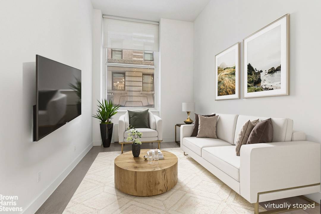 This expansive north facing one bedroom spans 866 square feet and features soaring 10' ceilings, enhancing volume throughout.