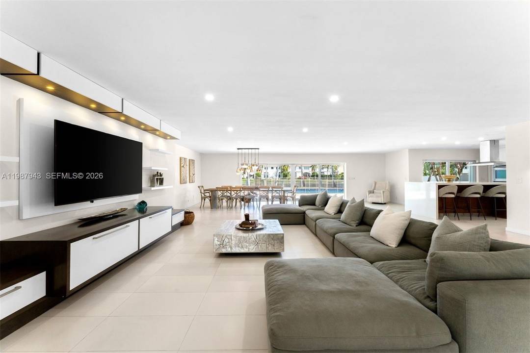 Modern waterfront residence with private dock and deck, offering open water views and a beautifully designed backyard setting.