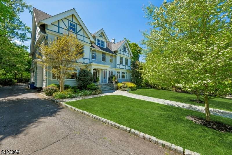 Exquisite Tudor Revival masterpiece situated on a rare.