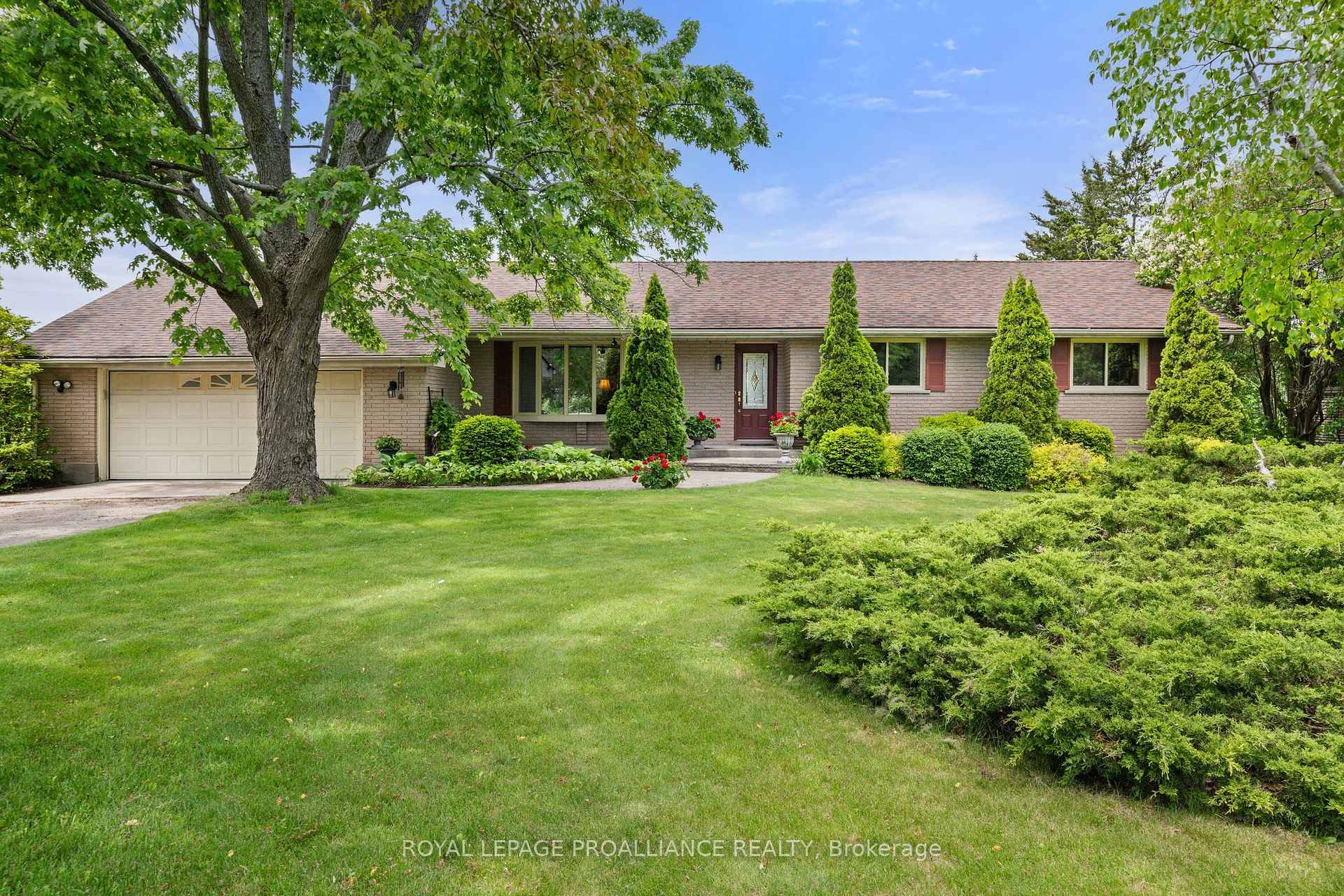 Overlooking the Bay of Quinte, this sprawling walk out bungalow with in ground pool is situated on an elevated 1.