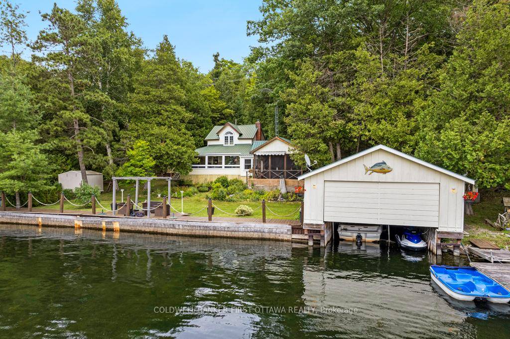 On Big Rideau Lake in a protected sheltered cove, classic lakehouse for all year vacation retreat or potential full time family home.