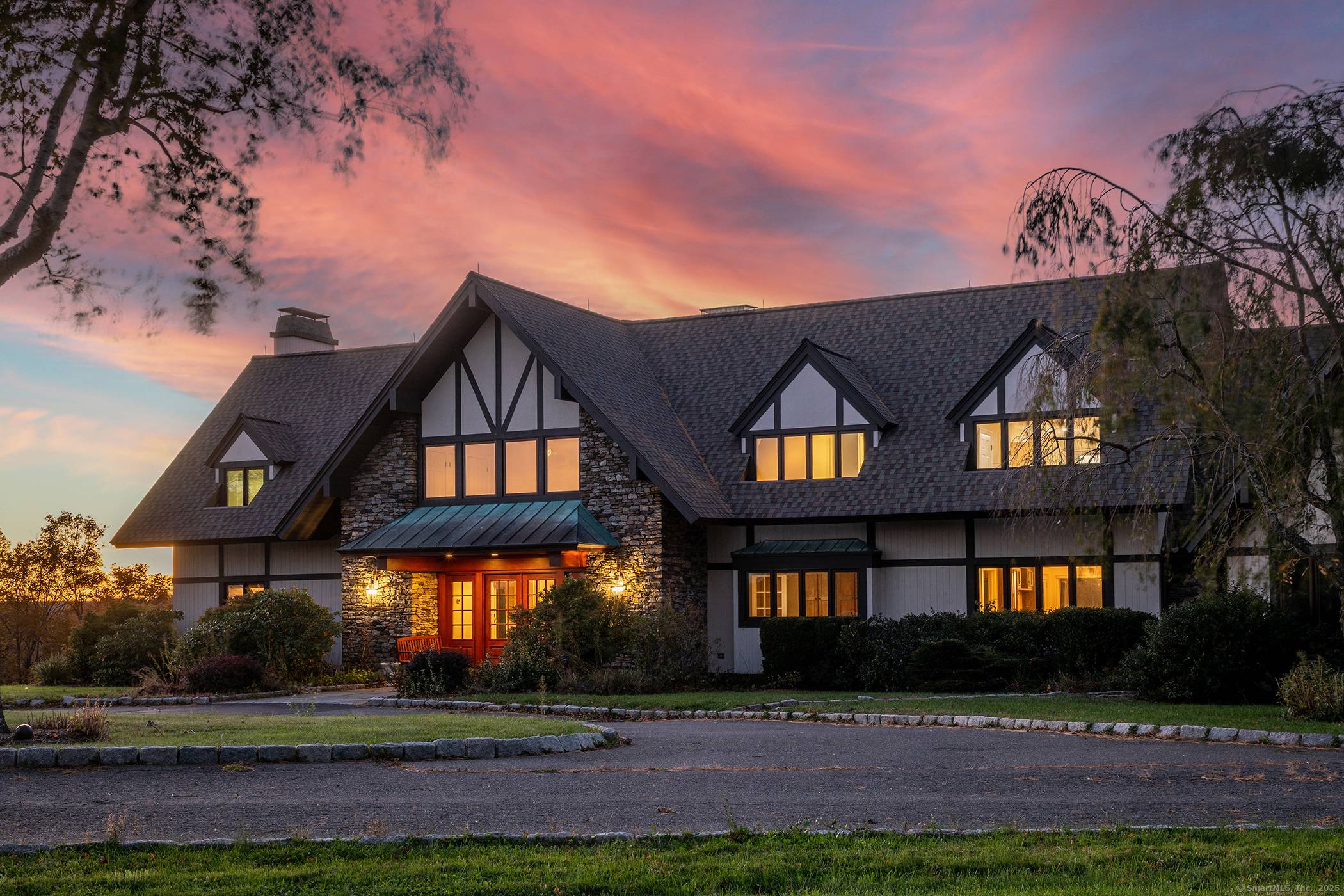 Discover refined country living in this remarkable Woodbury estate set on 33.