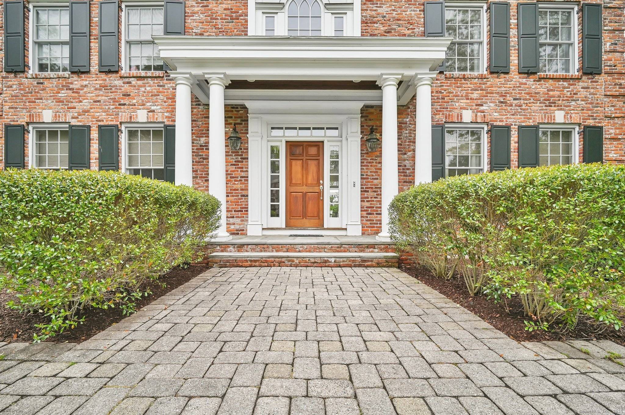 This magnificent brick and clapboard estate offers elegance sophistication with every detail meticulously crafted for refined living.