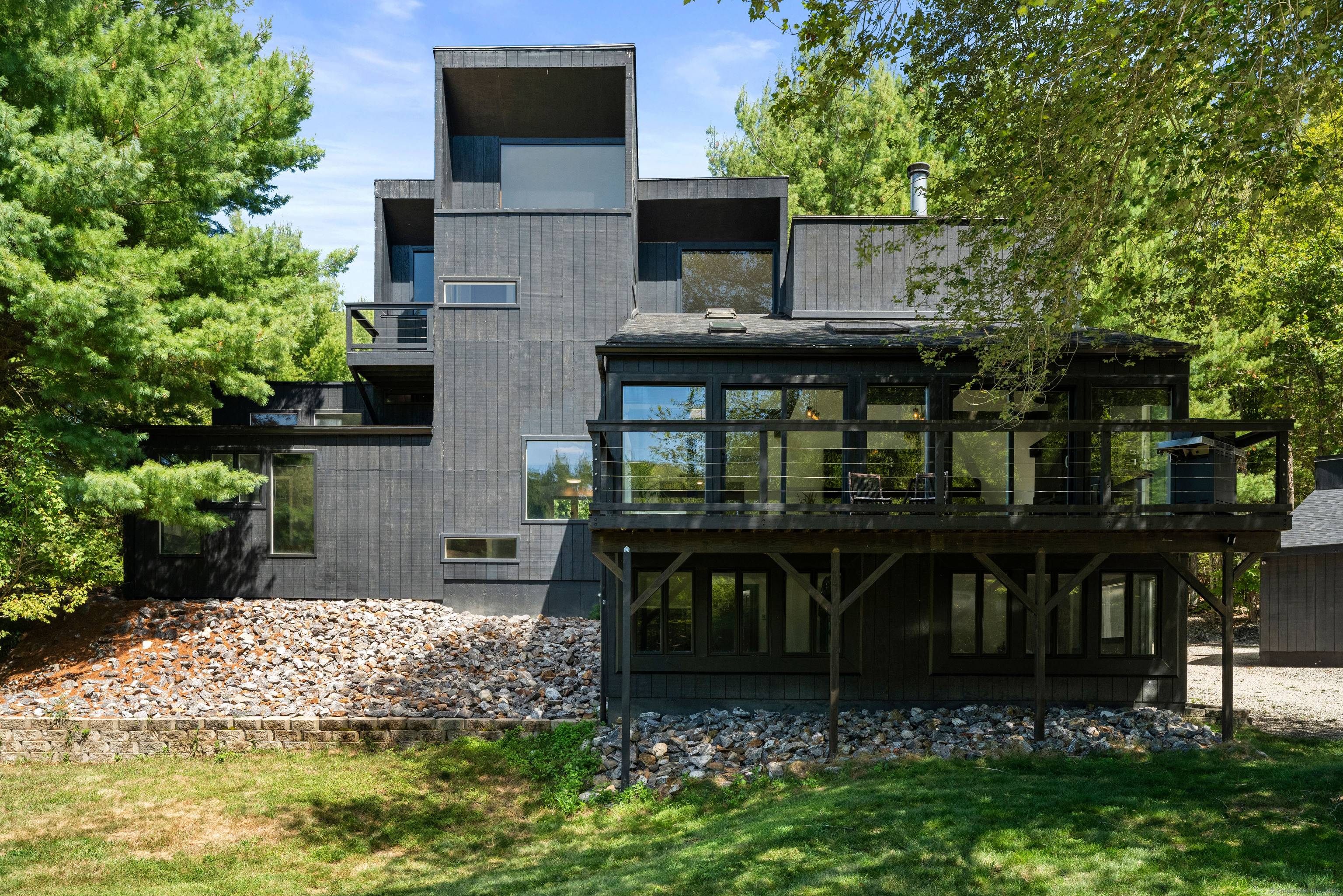 The escape begins the moment you turn onto the perfectly etched country drive, where a winding dirt road leads through the meadow revealing a distinctive contemporary home thoughtfully remodeled to ...