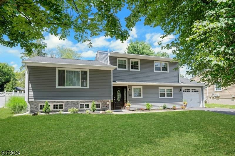 Beautifully Updated 4 Level Split with Open Concept LivingThis spacious and thoughtfully updated home features a stunning new kitchen with vaulted ceilings, quartz countertops, and stainless steel appliances refrigerator, oven, ...