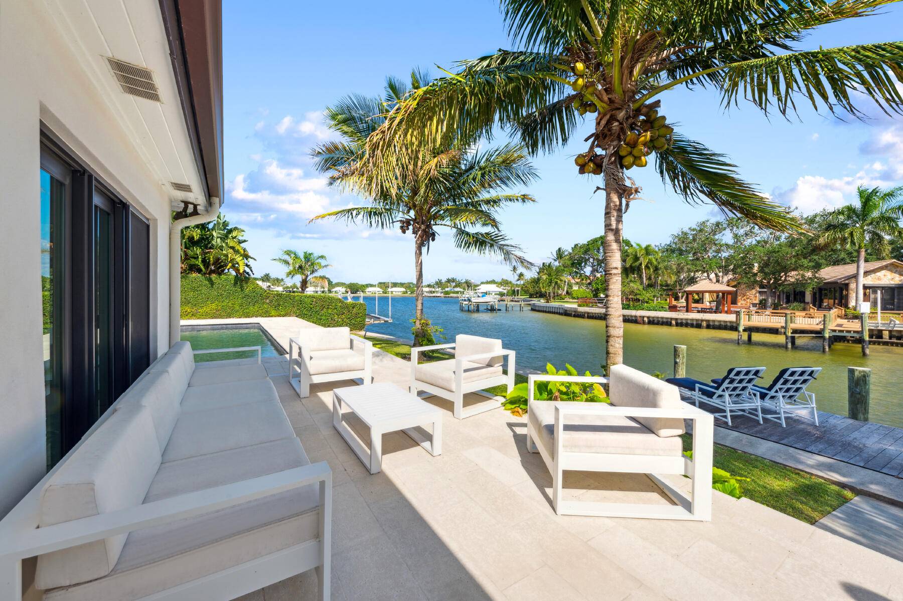 This striking 4 bedroom, 3 bath plus a den, ranch style waterfront home is in the family friendly gated community of Hidden Key in North Palm Beach.