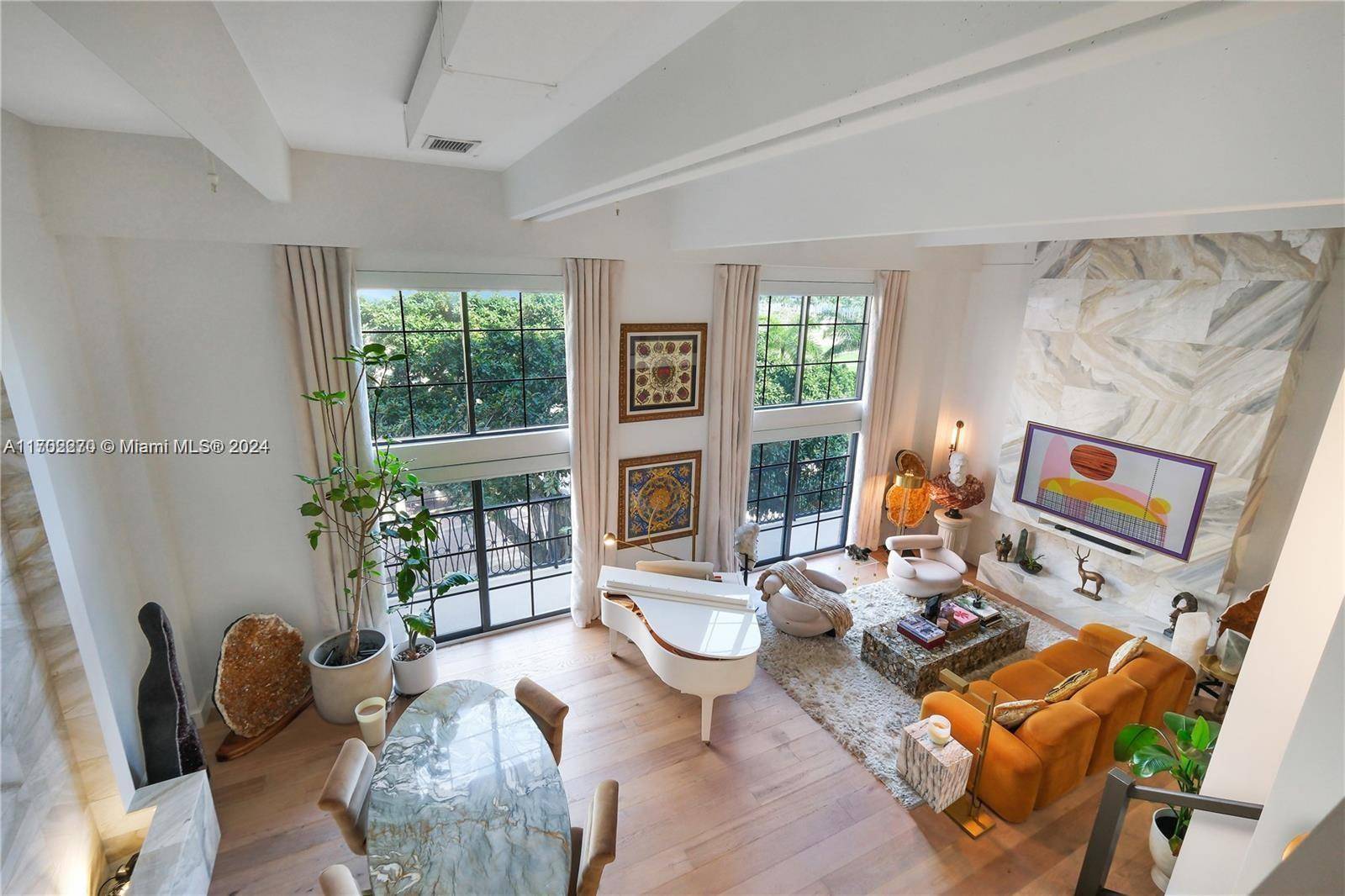 Welcome home to this jaw dropping double floor 17ft ceiling Treetop Loft in Downtown WPB.