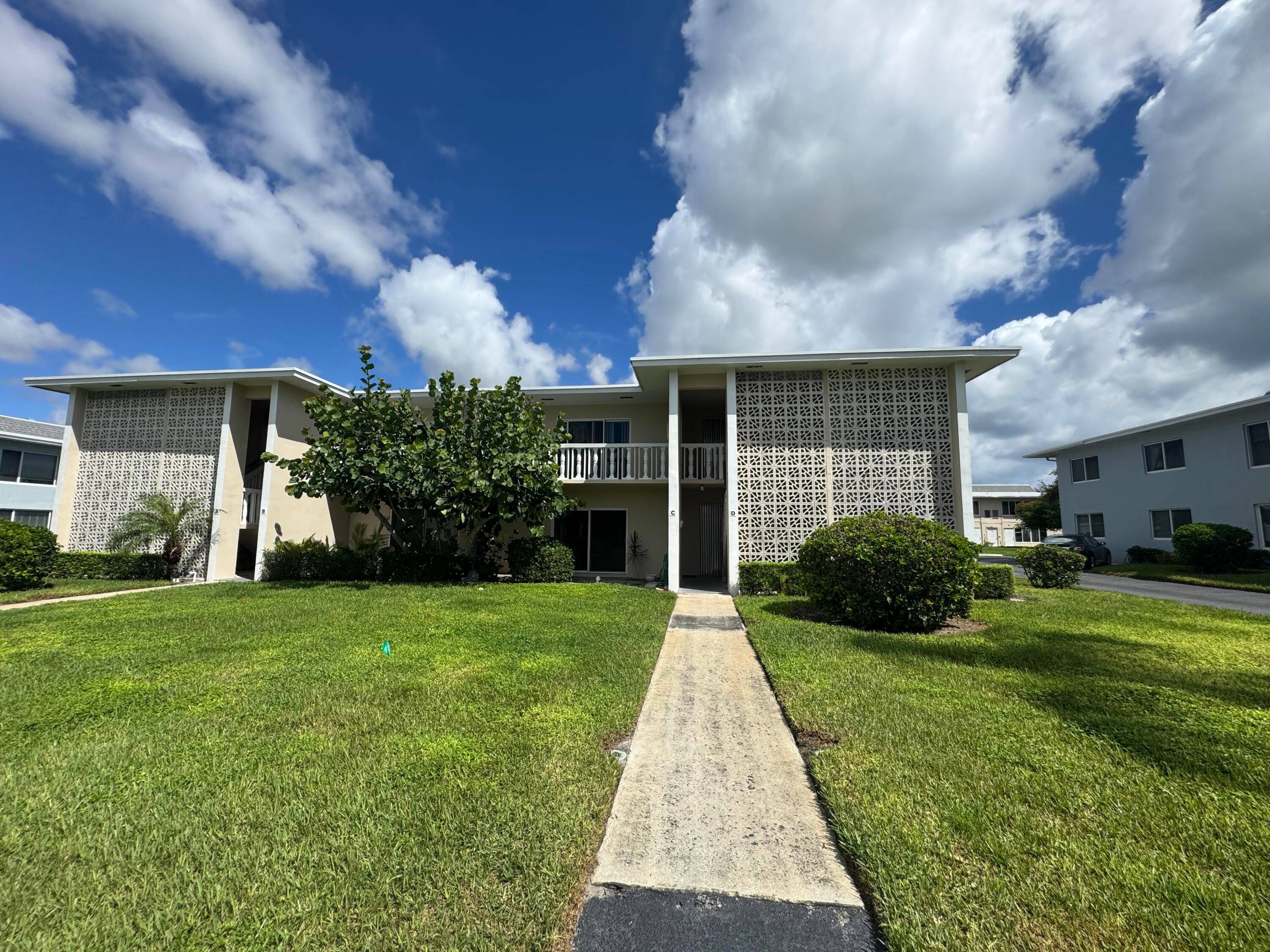 First floor condo featuring an updated kitchen with dishwasher and trash compactor, updated bathroom with a separate vanity area.