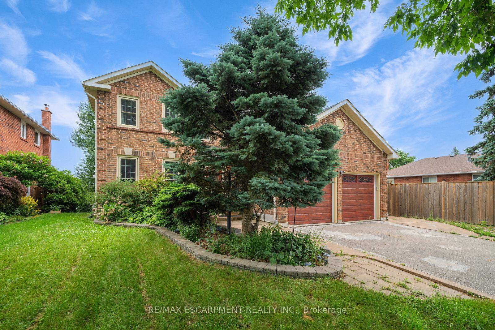 Welcome to 102 Crawford Rose Drive, a large 2 storey home featuring 4 bedrooms, 3 1 bathrooms, a finished basement with a backyard walkout, a double garage, and great curb ...