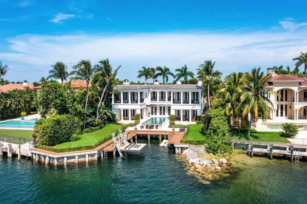 Welcome to this extraordinary private, gated waterfront estate, nestled within Boca Raton's most prestigious enclave.