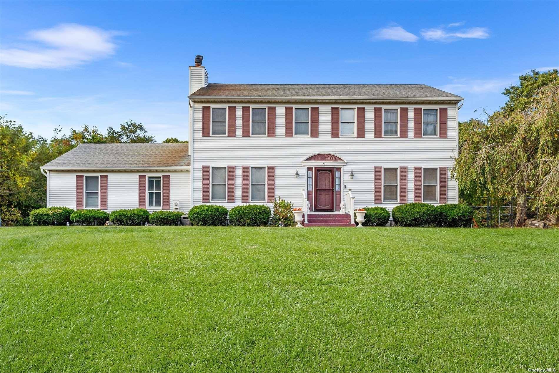 Motivated seller willing to entertain all reasonable offers Welcome to this stunning Center Hall Colonial set on over an acre in Manorville's desirable South Manor Estates.
