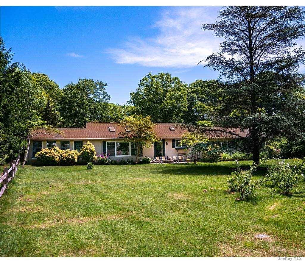 This newly renovated and freshly painted modern ranch with Central AC, a heated pool and water views is located on a lovely private road hugging the Coecles Harbor coastline.